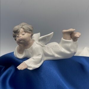 Lladro “Angel Laying Down" from the renowned Spanish porcelain brand.